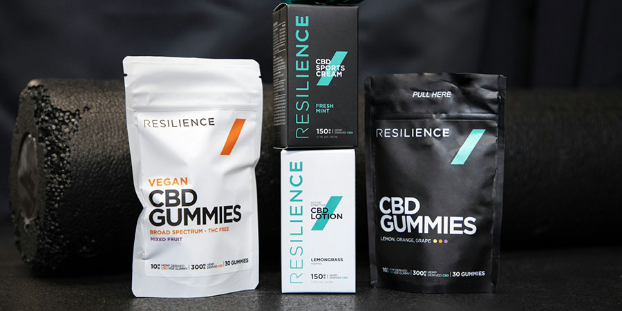 two packs of Resilience CBD gummies, a box of Resilience CBD cream and CBD lotion